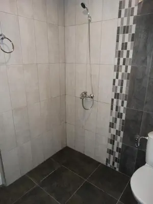 a bathroom with a shower with a toilet at Apartments DIEM in Samokov
