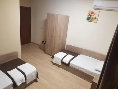 a small room with two beds and a cabinet at Twain Apart&Rooms in Sofia