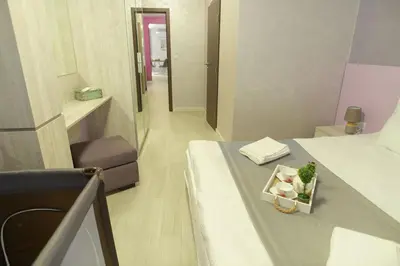 a room with a bed with a tray of flowers on it at Noris Apart with Garage in Plovdiv