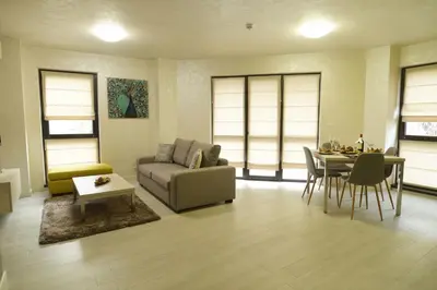a living room with a couch and a table at Noris Apart with Garage in Plovdiv