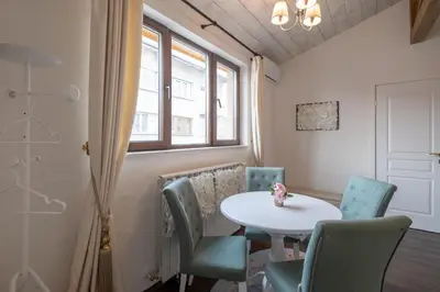 a room with a table and chairs and a window at 1-Bedroom Designer Apartment on Hristo Belchev Str in Sofia