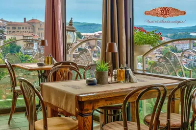 a restaurant with a table and chairs and a large window at 1-Bedroom Designer Apartment on Hristo Belchev Str in Sofia