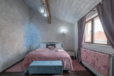 a bedroom with a bed with a pink blanket at 1-Bedroom Designer Apartment on Hristo Belchev Str in Sofia