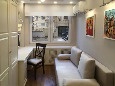 a living room with a couch and a chair and a window at A luxury apartment with patio and BBQ in Sofia