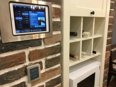 a tv mounted to a brick wall with a tv on it at A luxury apartment with patio and BBQ in Sofia