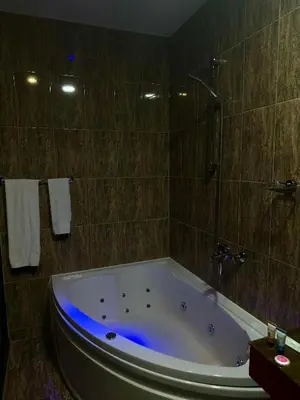 a bathroom with a bath tub with blue lighting at Central Point Boutique Hotel in Sofia