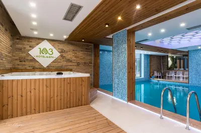 a swimming pool with a tub in a house at 103 Degrees Hotel & Spa in Sapareva Banya