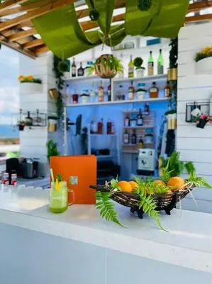 a counter with a basket of oranges and a laptop at 103 Degrees Hotel & Spa in Sapareva Banya