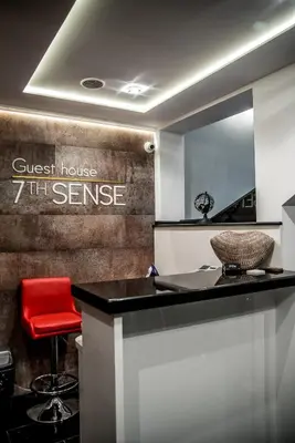 a kitchen with a counter and a red stool at Boutique Guest house 7th Sense in Plovdiv