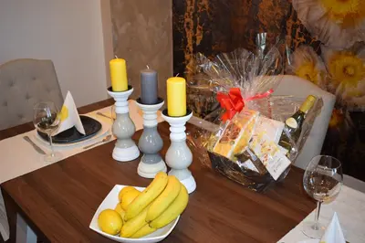 a table with a plate of bananas and candles at Guest House Amaya in Plovdiv