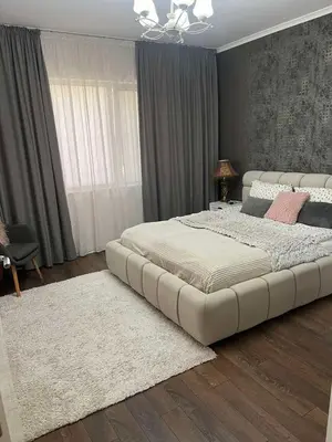 a bedroom with a large white bed with a white rug at Guest House Amaya in Plovdiv