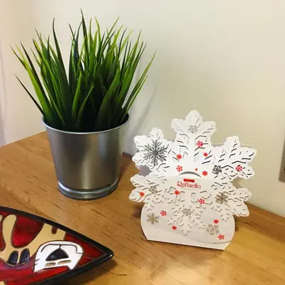 a table with a potted plant and a christmas tree on it at Snow Apartment - Bansko in Bansko