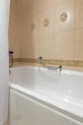 a white bath tub in a bathroom at Downtown Bansko Resort in Bansko