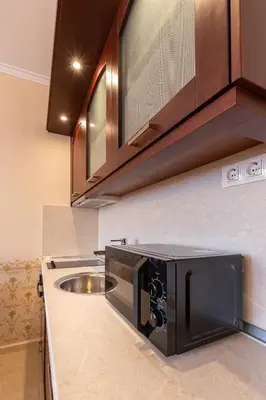 a kitchen with a sink and a microwave at Downtown Bansko Resort in Bansko