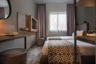 a hotel room with two beds and a window at THE STAY Boutique Hotel Central Square - Free Compliments - Free Wi-Fi - TOP LOCATION - Nearby Paid Parking in Plovdiv