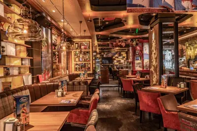 a restaurant with wooden tables and red chairs at THE STAY Boutique Hotel Central Square - Free Compliments - Free Wi-Fi - TOP LOCATION - Nearby Paid Parking in Plovdiv