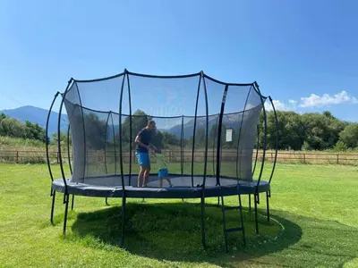 a man and a child playing on a trampoline at Thermal Hotel Seven Seasons in Banya