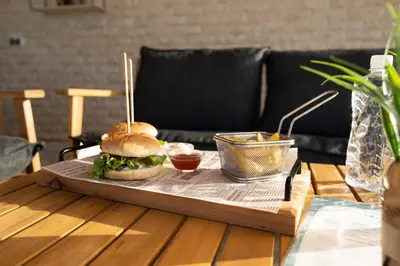 a sandwich on a wooden tray on a table at Thermal Hotel Seven Seasons in Banya