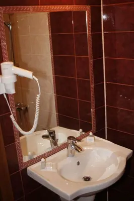a bathroom with a sink and a mirror at Hotel Elegance in Asenovgrad