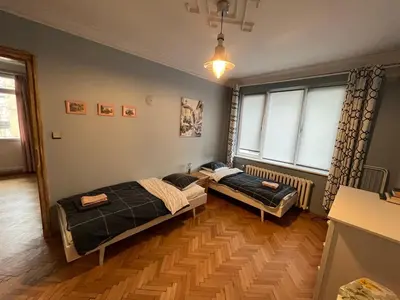two beds in a room with two windows at Your Space in Sofia in Sofia