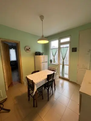 a kitchen with a table and chairs and a refrigerator at Your Space in Sofia in Sofia