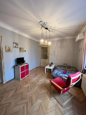 a living room with a bed and a table at Your Space in Sofia in Sofia