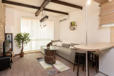a living room with a couch and a table at The Balkan in Plovdiv