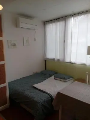 a small bedroom with a bed and a window at Студио Бижу in Hisarya