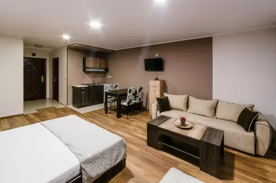 a living room with a couch and a table at Family Hotel Ring & Thermal in Kyustendil