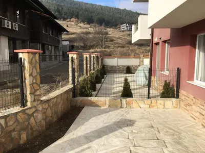 a walkway in front of a building with a fence at ApartVel apartment 1 in Velingrad