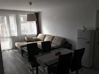 a living room with a couch and a table and chairs at ApartVel apartment 1 in Velingrad