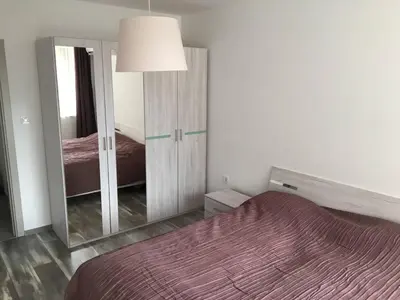 a bedroom with a bed and a large mirror at ApartVel apartment 1 in Velingrad