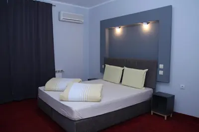 a bedroom with a large bed with two pillows at Hotel Color in Asenovgrad