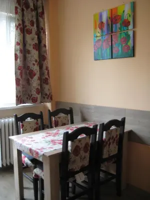 a dining room table and chairs with a table and a window at Maria Louisa Apartment in Sofia