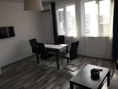 a living room with a dining room table and chairs at ApartVel apartment 3 in Velingrad