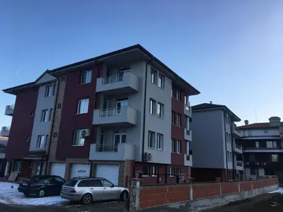 a building with two cars parked in front of it at ApartVel apartment 3 in Velingrad
