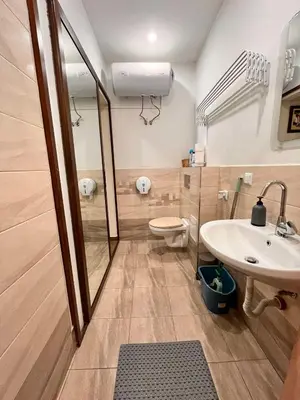 a bathroom with a sink and a toilet and a mirror at Exceptional Refurnished Studio TOP Location in Sofia