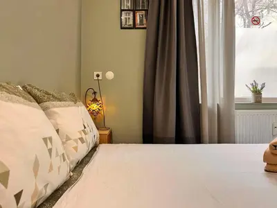 a bedroom with a bed with white sheets and a window at Exceptional Refurnished Studio TOP Location in Sofia