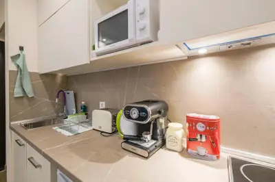 a kitchen counter with a coffee maker on it at Exceptional Refurnished Studio TOP Location in Sofia