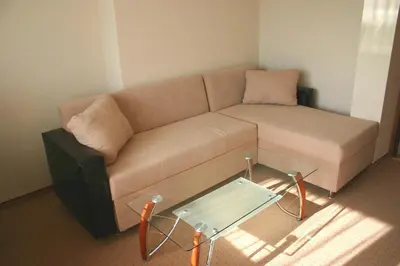 a living room with a couch and a glass table at Ribkata Family Hotel in Smolyan