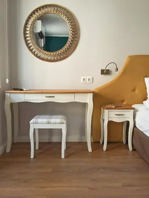 a bedroom with a desk and a mirror and a bed at Momenti & Colori Studios in Sofia