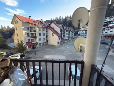 a balcony with a view of a street and buildings at Apartment 9 in Pamporovo