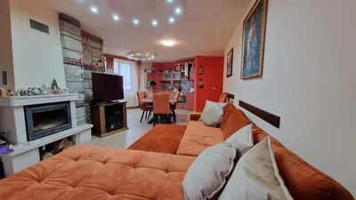 a living room with a couch and a television at Apartment 9 in Pamporovo