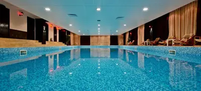 a large blue swimming pool in a hotel at Apartment Аlex in Grand Monastery Pamporovo in Pamporovo