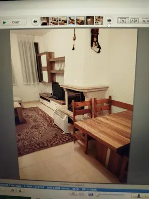 a living room with a table and a fireplace at Apartment Аlex in Grand Monastery Pamporovo in Pamporovo