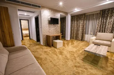 a living room with a couch and a table at Hotel Andon Angelov in Sandanski