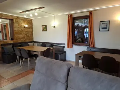 a restaurant with a couch and tables and chairs at Guest house Lidia in Tsigov Chark
