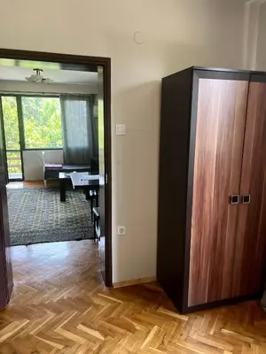 a room with a large wooden cabinet and a desk at Bankya Guest House - Sofia in Bankya