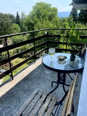 a table and two chairs on a balcony with a view at Bankya Guest House - Sofia in Bankya