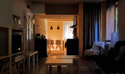 a living room with a couch and a table in a room at Red Door Apartment in Sofia